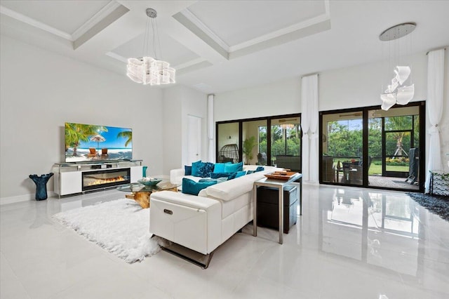 living room with baseboards, coffered ceiling, a towering ceiling, a glass covered fireplace, and a notable chandelier