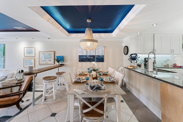 700 NE 20th Ln, Boynton Beach, FL 33435 - dining area with light tile patterned floors, a raised ceiling, an inviting chandelier, and crown molding