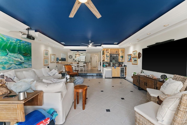 700 NE 20th Ln, Boynton Beach, FL 33435 - living area with tile patterned flooring, a bar, a raised ceiling, and a ceiling fan