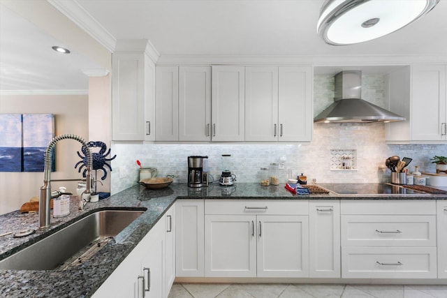 700 NE 20th Ln, Boynton Beach, FL 33435 - kitchen featuring a sink, decorative backsplash, white cabinets, crown molding, and wall chimney range hood