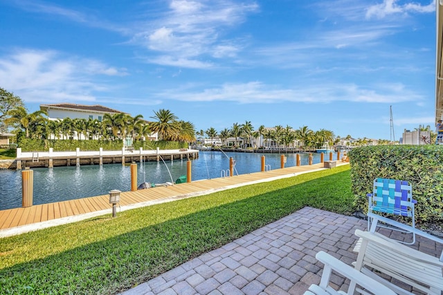 dock area featuring a lawn and a water view