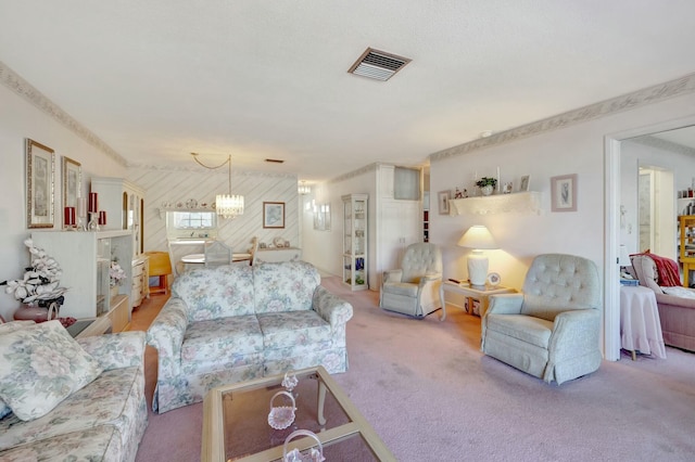 carpeted living area featuring visible vents and a notable chandelier