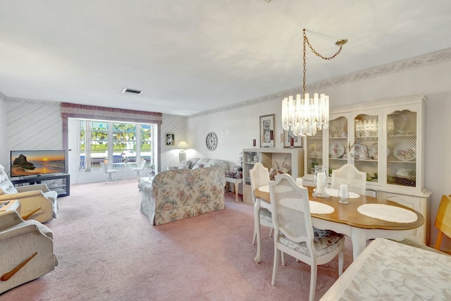 dining area featuring a notable chandelier, carpet, and visible vents