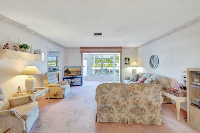 carpeted living area featuring a wealth of natural light and visible vents