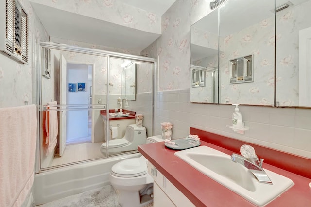 bathroom with visible vents, shower / bath combination with glass door, wallpapered walls, tile walls, and toilet