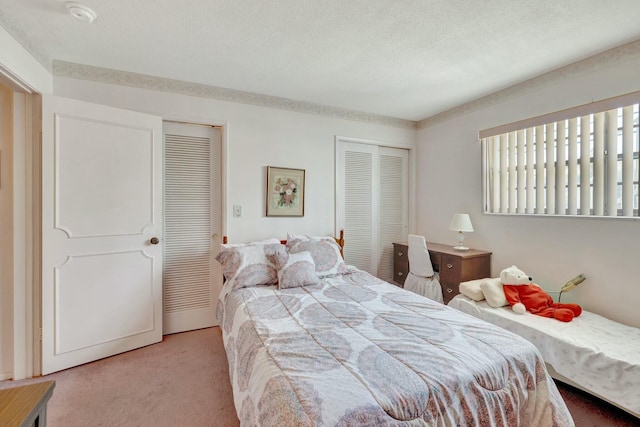 bedroom featuring multiple closets, carpet, and a textured ceiling