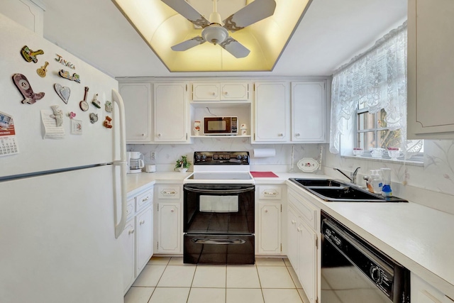 kitchen featuring a sink, tasteful backsplash, range with electric stovetop, freestanding refrigerator, and dishwashing machine