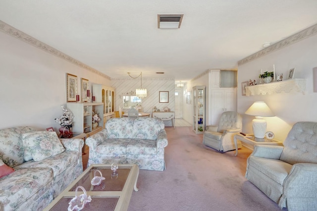 carpeted living area featuring visible vents and a chandelier