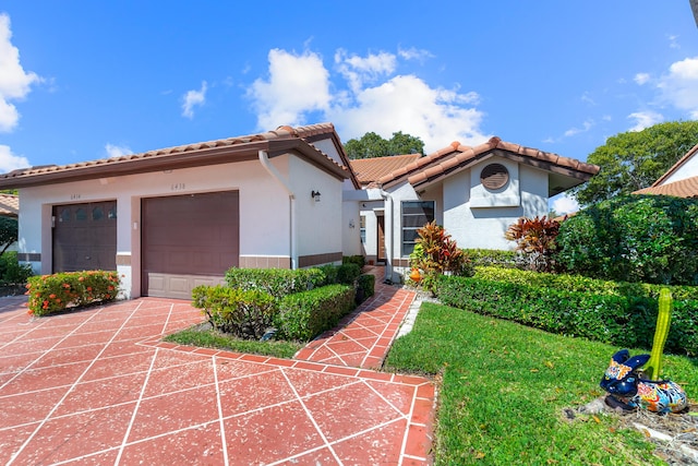 6438 Pointe Pleasant Cir, Delray Beach, FL 33484 - mediterranean / spanish house featuring a tile roof, concrete driveway, stucco siding, and an attached garage