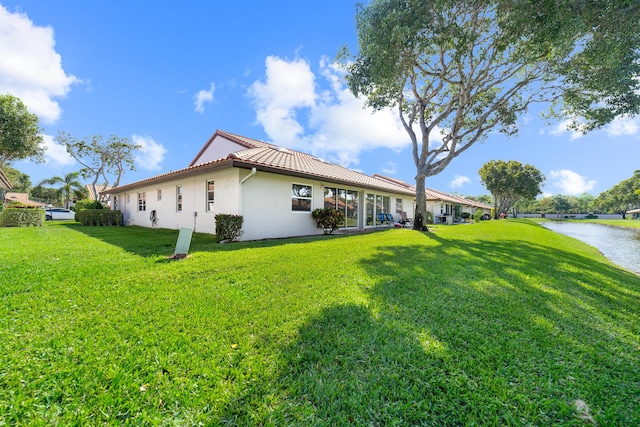 6438 Pointe Pleasant Cir, Delray Beach, FL 33484 - view of property exterior with stucco siding, a yard, a water view, and a tiled roof