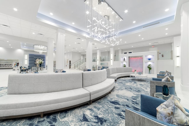 6438 Pointe Pleasant Cir, Delray Beach, FL 33484 - living area with a tray ceiling, recessed lighting, a chandelier, decorative columns, and stairs