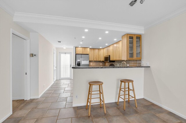 3101 S Ocean Blvd Unit 1002, Highland Beach, FL 33487 - kitchen with stainless steel appliances, recessed lighting, tasteful backsplash, a peninsula, and glass insert cabinets