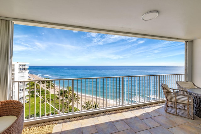 balcony with a view of the beach and a water view