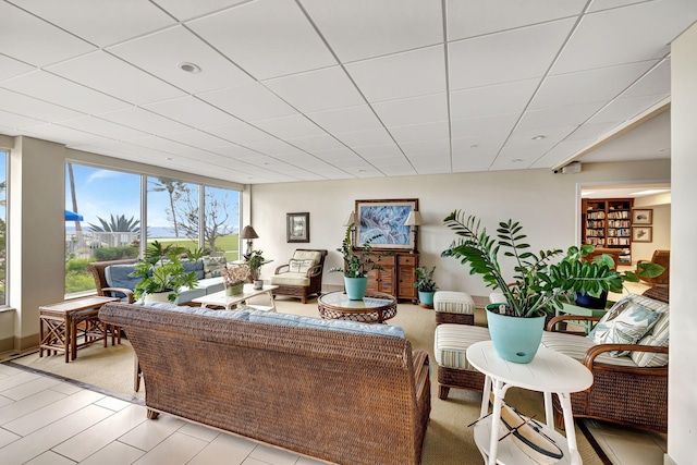 living room with a paneled ceiling