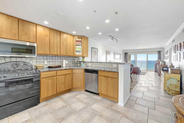 3101 S Ocean Blvd Unit 1002, Highland Beach, FL 33487 - kitchen featuring stainless steel appliances, ornamental molding, a peninsula, backsplash, and light stone counters