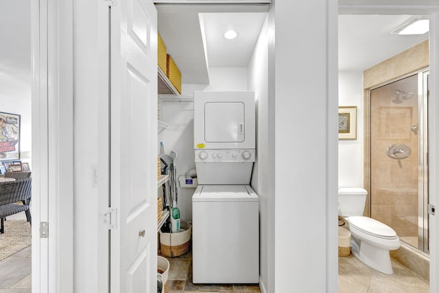 3101 S Ocean Blvd Unit 1002, Highland Beach, FL 33487 - laundry area featuring stacked washer and clothes dryer and light tile patterned floors