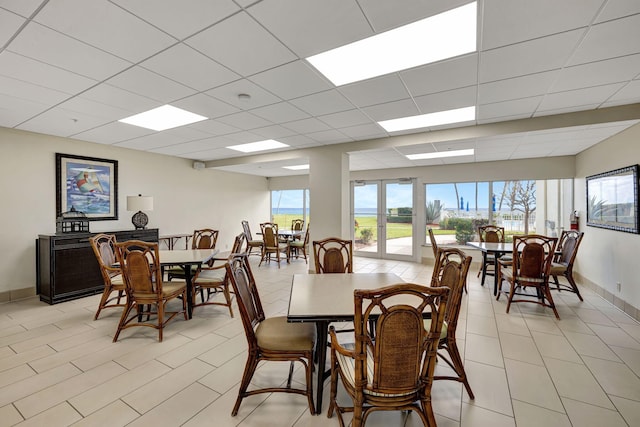 3101 S Ocean Blvd Unit 1002, Highland Beach, FL 33487 - dining space with baseboards, light tile patterned floors, and a drop ceiling