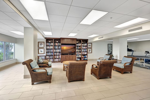 3101 S Ocean Blvd Unit 1002, Highland Beach, FL 33487 - living area with baseboards, light tile patterned floors, a drop ceiling, and built in shelves