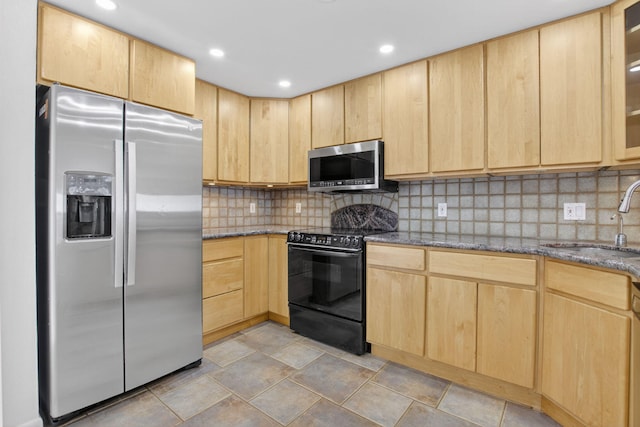 3101 S Ocean Blvd Unit 1002, Highland Beach, FL 33487 - kitchen featuring stainless steel appliances, light brown cabinets, a sink, dark stone countertops, and backsplash