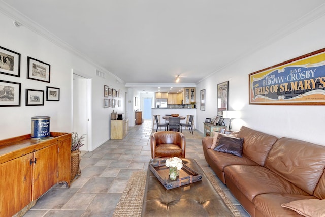 living area with visible vents and crown molding