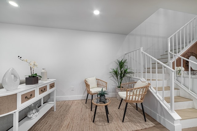 sitting room featuring recessed lighting, baseboards, wood finished floors, and stairs