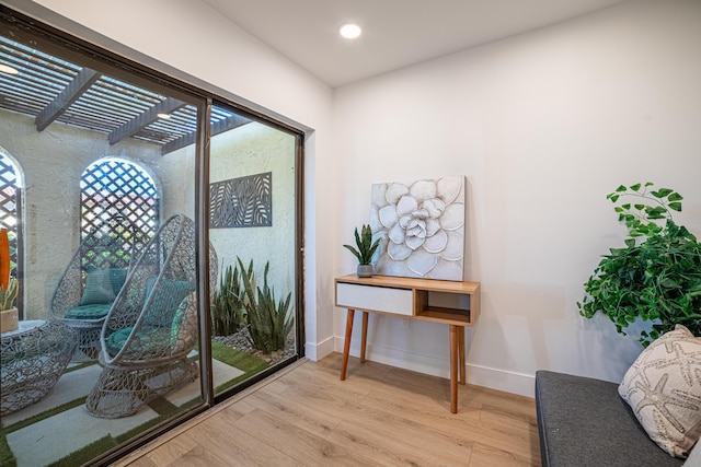 living area featuring recessed lighting, baseboards, and light wood finished floors