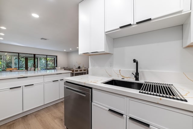 kitchen with dishwasher, white cabinets, visible vents, and light wood-type flooring