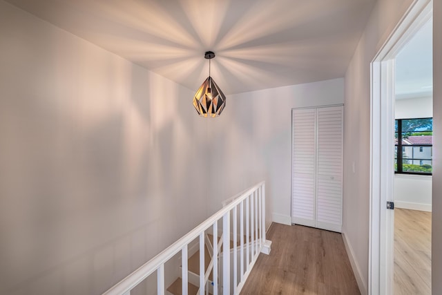 hall featuring wood finished floors and baseboards