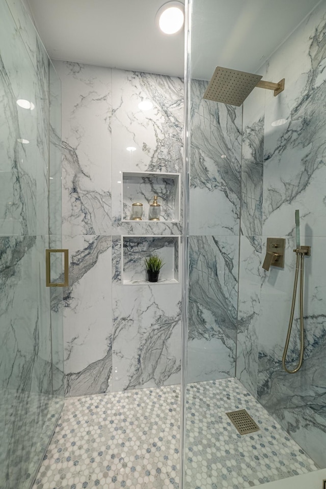 full bathroom featuring visible vents and a marble finish shower