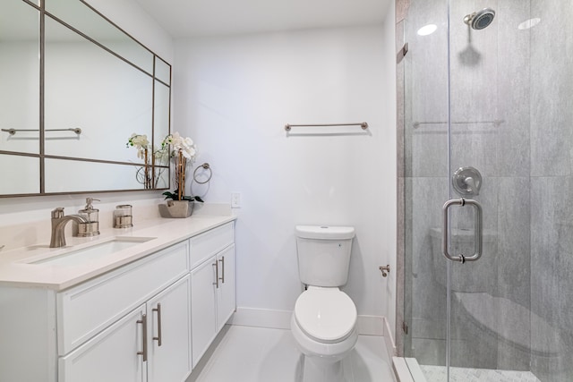 bathroom with tile patterned flooring, a shower stall, baseboards, toilet, and vanity