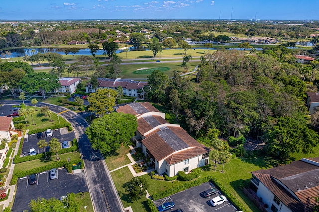 drone / aerial view with a water view and a residential view