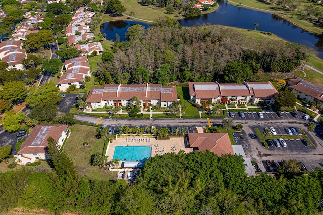 drone / aerial view with a water view and a residential view