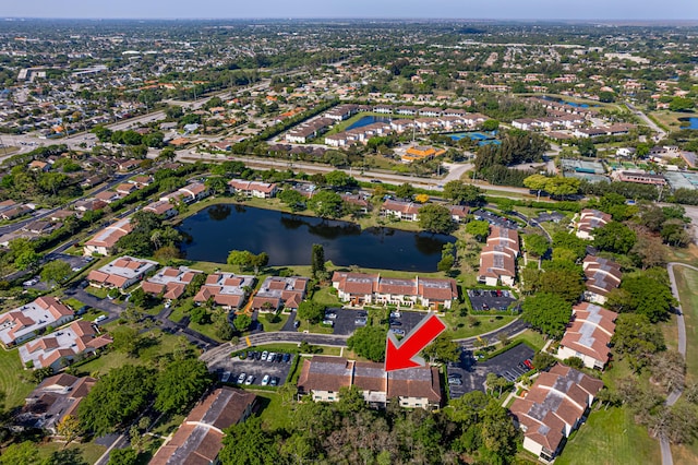 drone / aerial view featuring a residential view and a water view