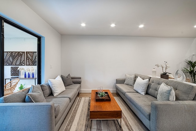 living area with recessed lighting, baseboards, and wood finished floors