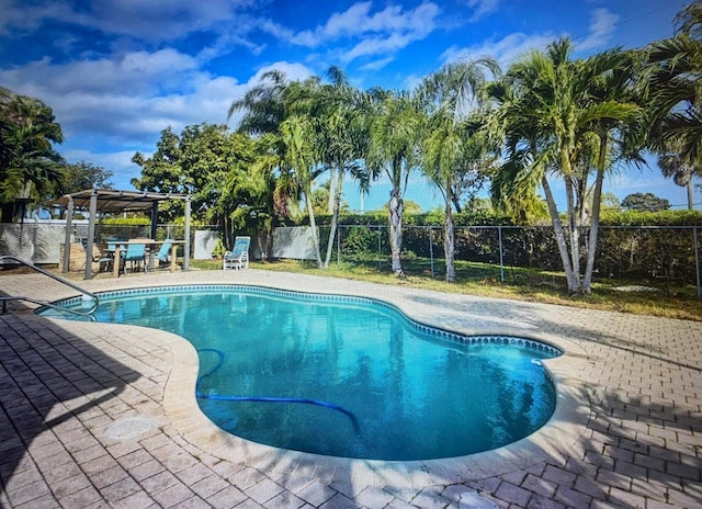 view of pool with a patio, a fenced backyard, a fenced in pool, and outdoor dry bar