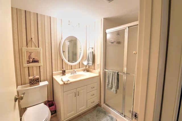 15 Southport Ln Unit E, Boynton Beach, FL 33436 - bathroom featuring toilet, a stall shower, and vanity