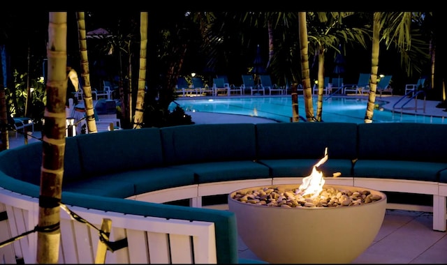 15 Southport Ln Unit E, Boynton Beach, FL 33436 - view of patio featuring a community pool and a fire pit