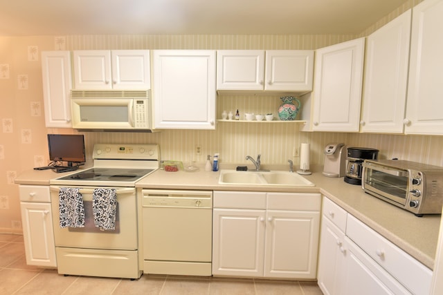 15 Southport Ln Unit E, Boynton Beach, FL 33436 - kitchen with white appliances, light tile patterned flooring, a sink, light countertops, and white cabinets