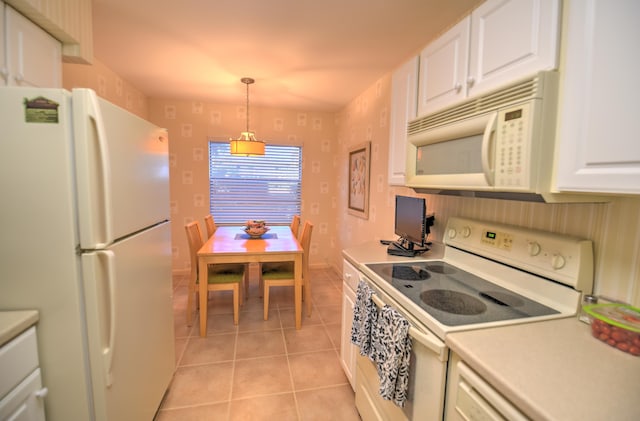 15 Southport Ln Unit E, Boynton Beach, FL 33436 - kitchen featuring light tile patterned flooring, white cabinets, white appliances, and light countertops