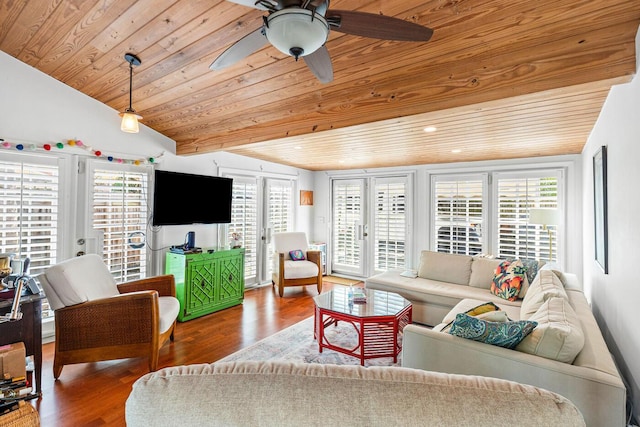 living room with a ceiling fan, lofted ceiling, wood finished floors, and a healthy amount of sunlight