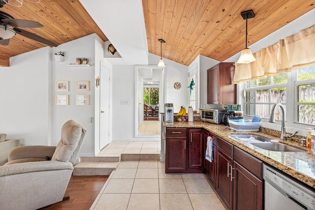 kitchen featuring decorative light fixtures, dishwasher, lofted ceiling, light tile patterned flooring, and a sink