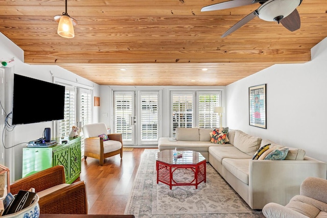 living area featuring a healthy amount of sunlight, wood ceiling, wood finished floors, and vaulted ceiling