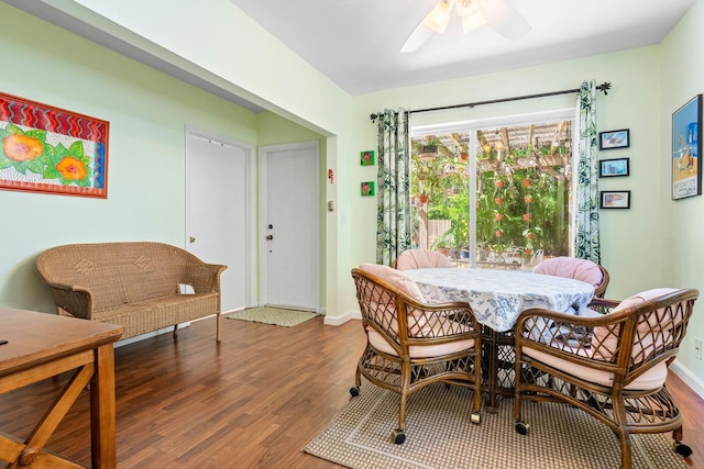 dining area featuring ceiling fan, baseboards, and wood finished floors