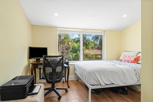 bedroom with recessed lighting and wood finished floors