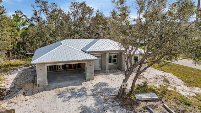 view of front facade with metal roof and an attached garage