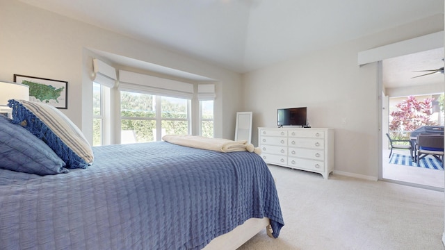 bedroom with lofted ceiling, carpet, and baseboards