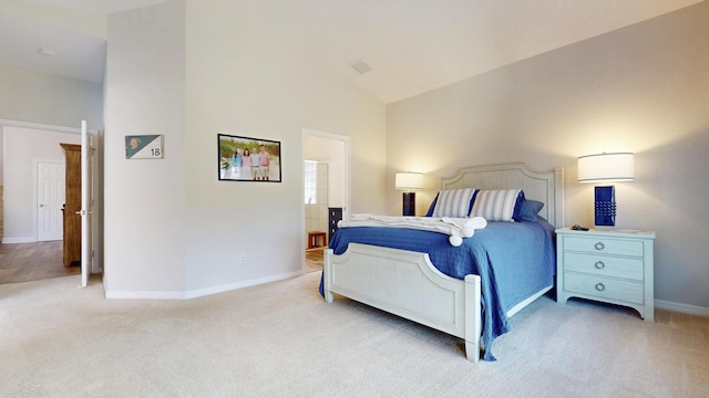 bedroom with high vaulted ceiling, visible vents, baseboards, and light carpet