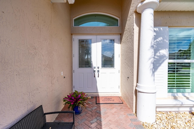 property entrance with stucco siding