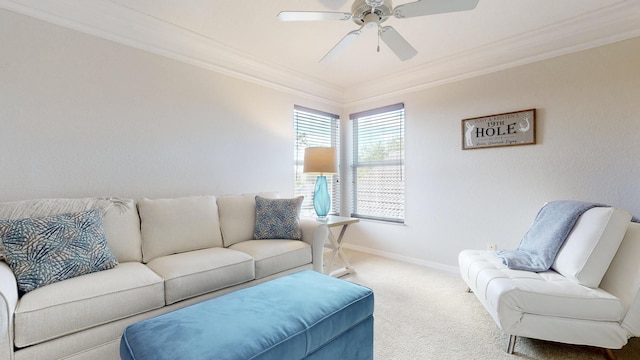 carpeted living room featuring baseboards, ornamental molding, and a ceiling fan