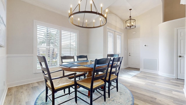 dining room featuring visible vents, baseboards, light wood-style floors, and an inviting chandelier